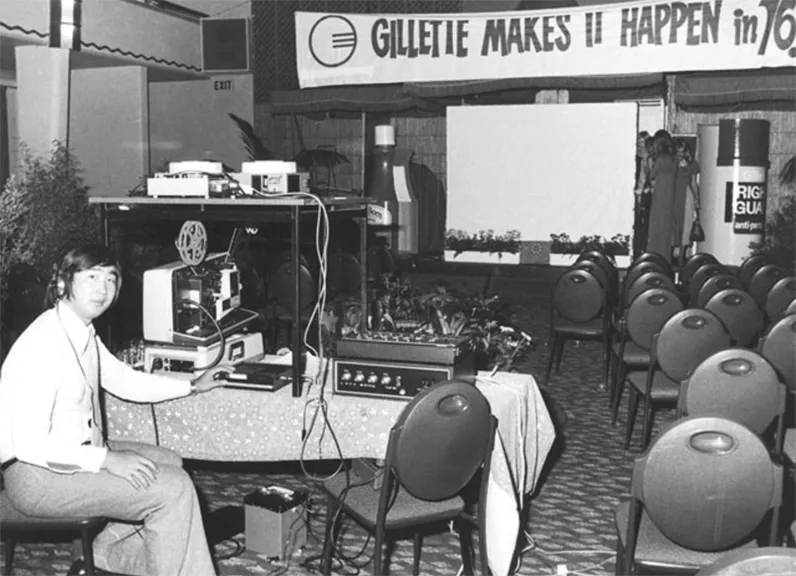 Archival photograph of camera operators filming a presentation at a Gillette event.
