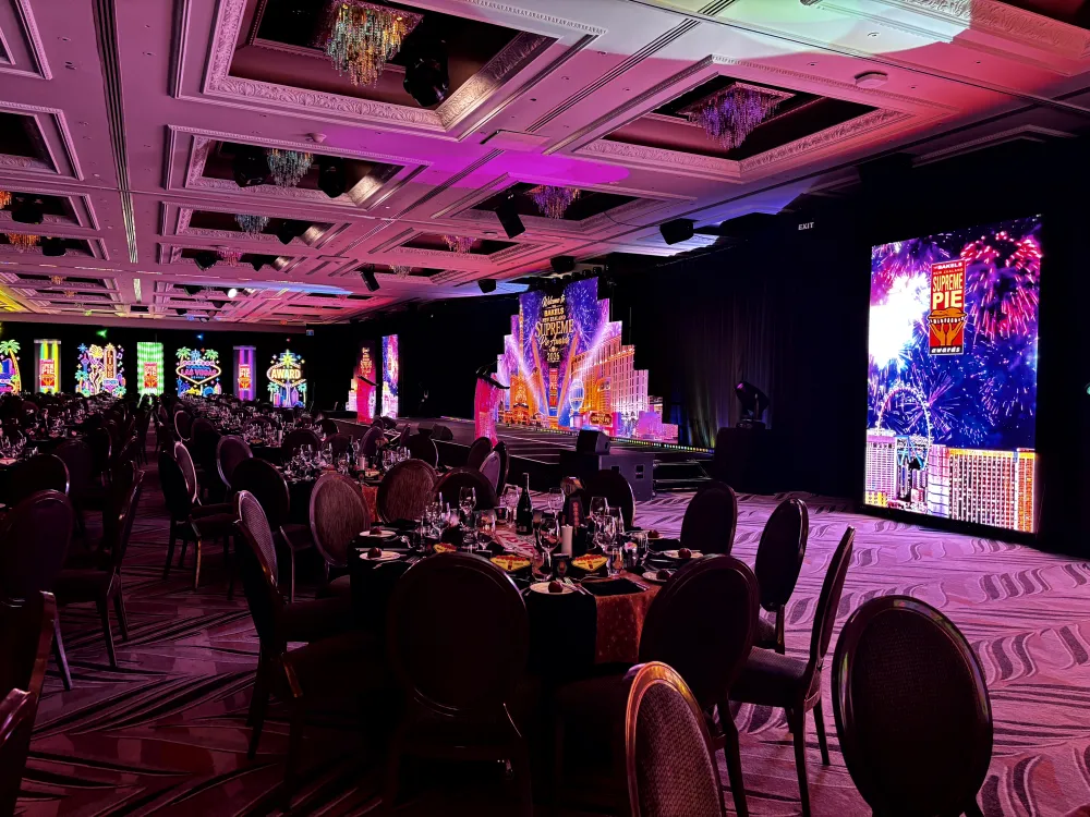 Supreme Pie Awards stage with colourful screens and banquet tables at Cordis.