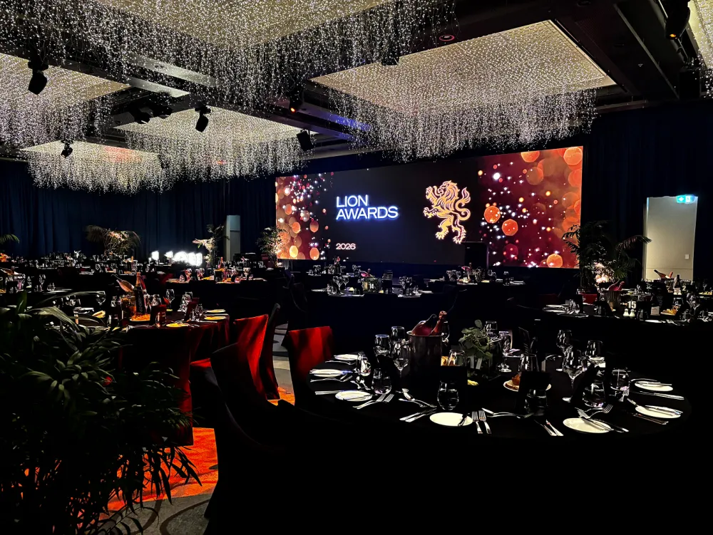 Lion Awards stage, video screen and banquet seating beneath a decorative ceiling.