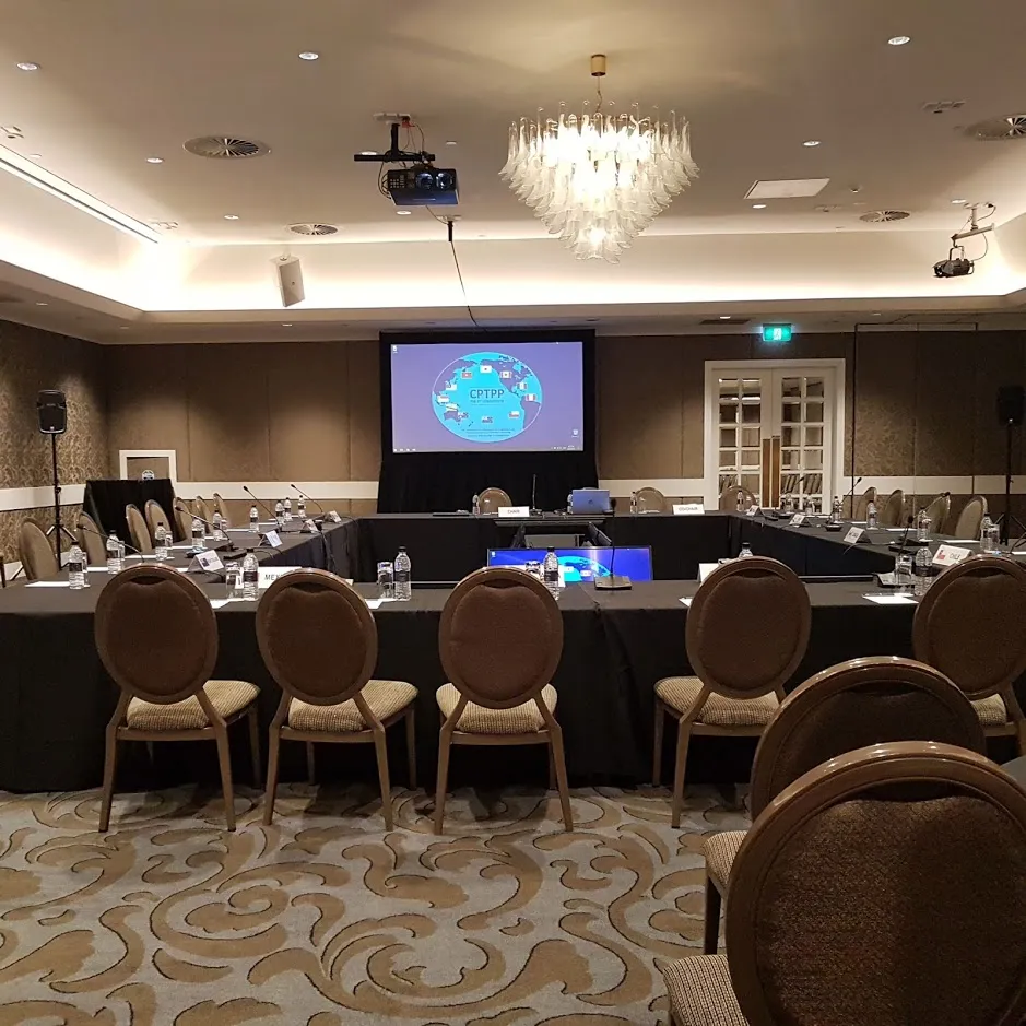 Conference room with round tables and a presentation screen.