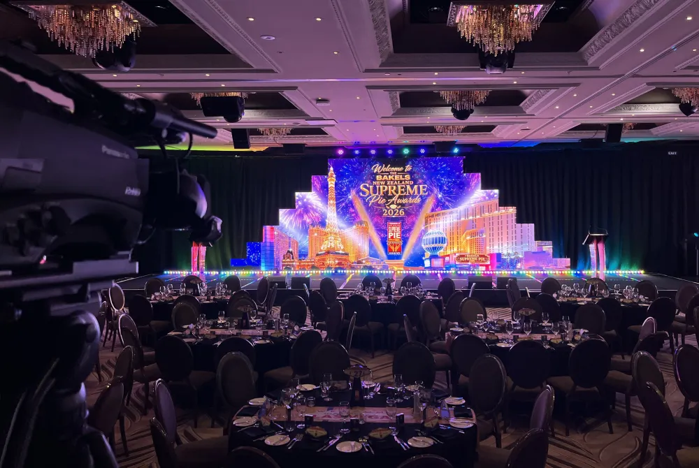 Illuminated stage backdrop and banquet seating at the Supreme Pie Awards.