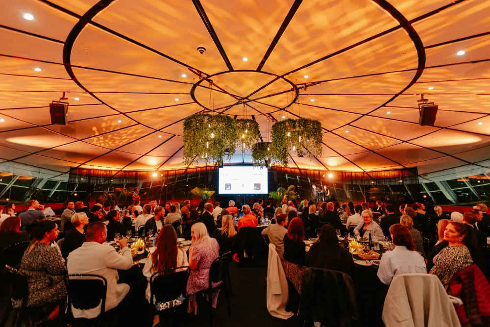 Guests seated beneath the illuminated dome at Auckland Museum.